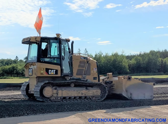 Stone spreader box on D5K CAT dozer